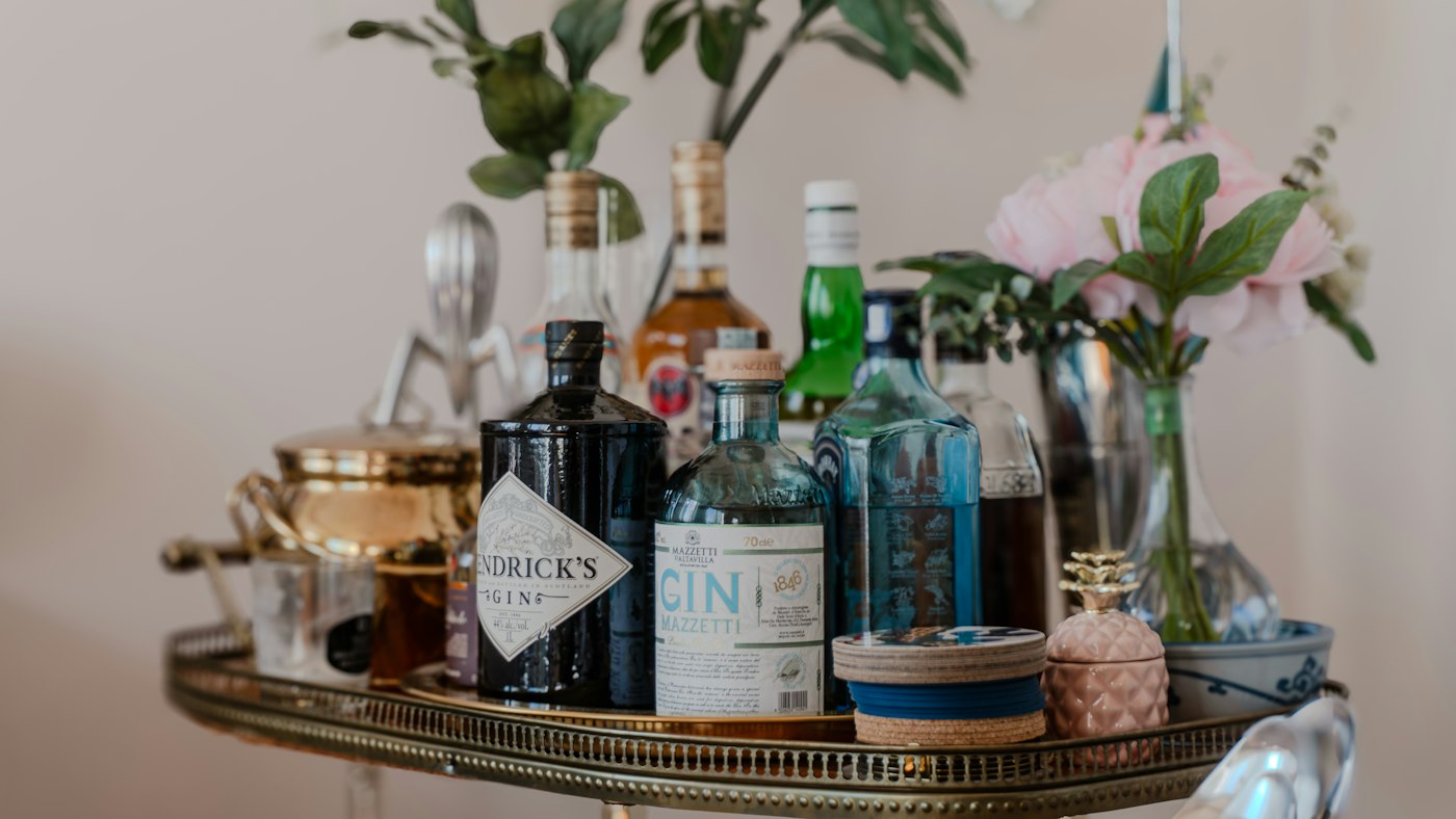 Villa bar cart stocked with spirits, mixers and glassware for guest arrival
